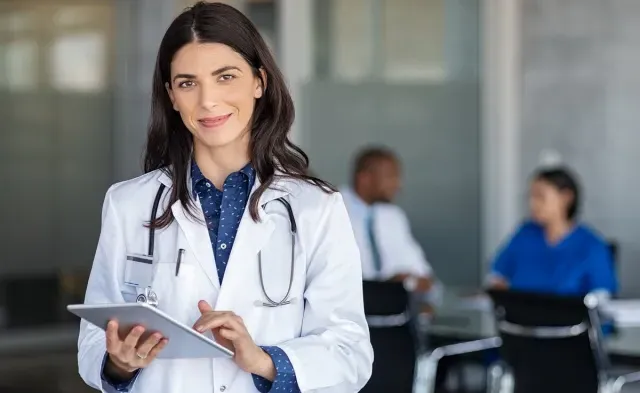 Nurse practitioner smiling in office after meeting with hospital administrators